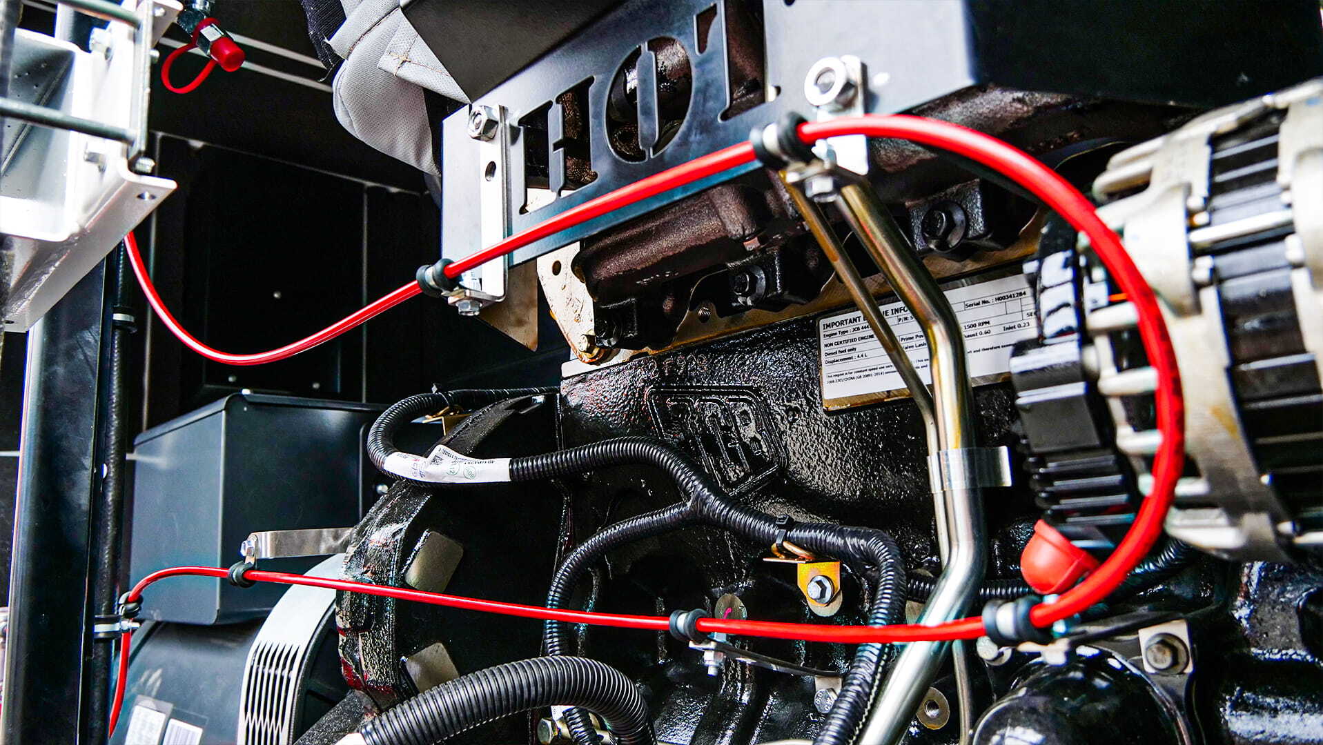 Red pneumatic detection tubing in a JCB engine bay