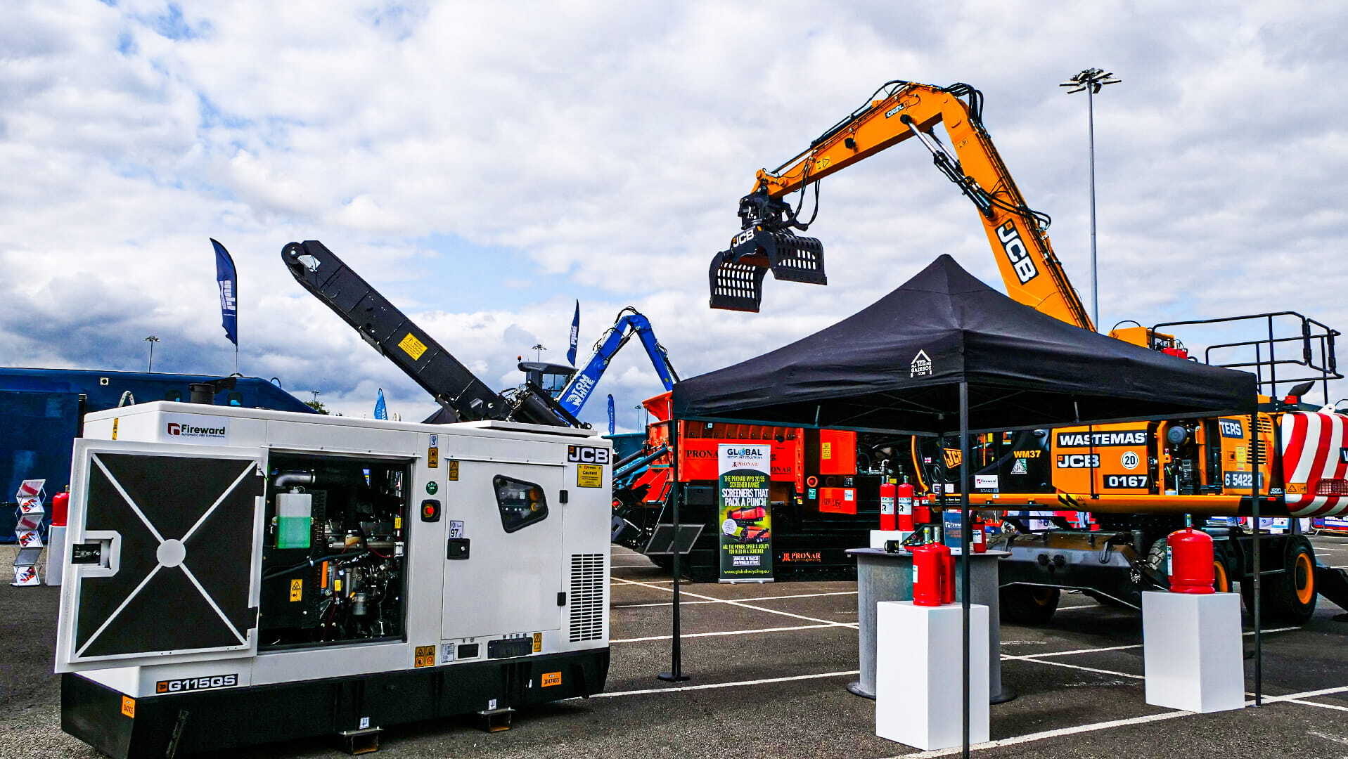 Various heavy plant displayed on the Fireward stand at the RWM waste recycling exhibition