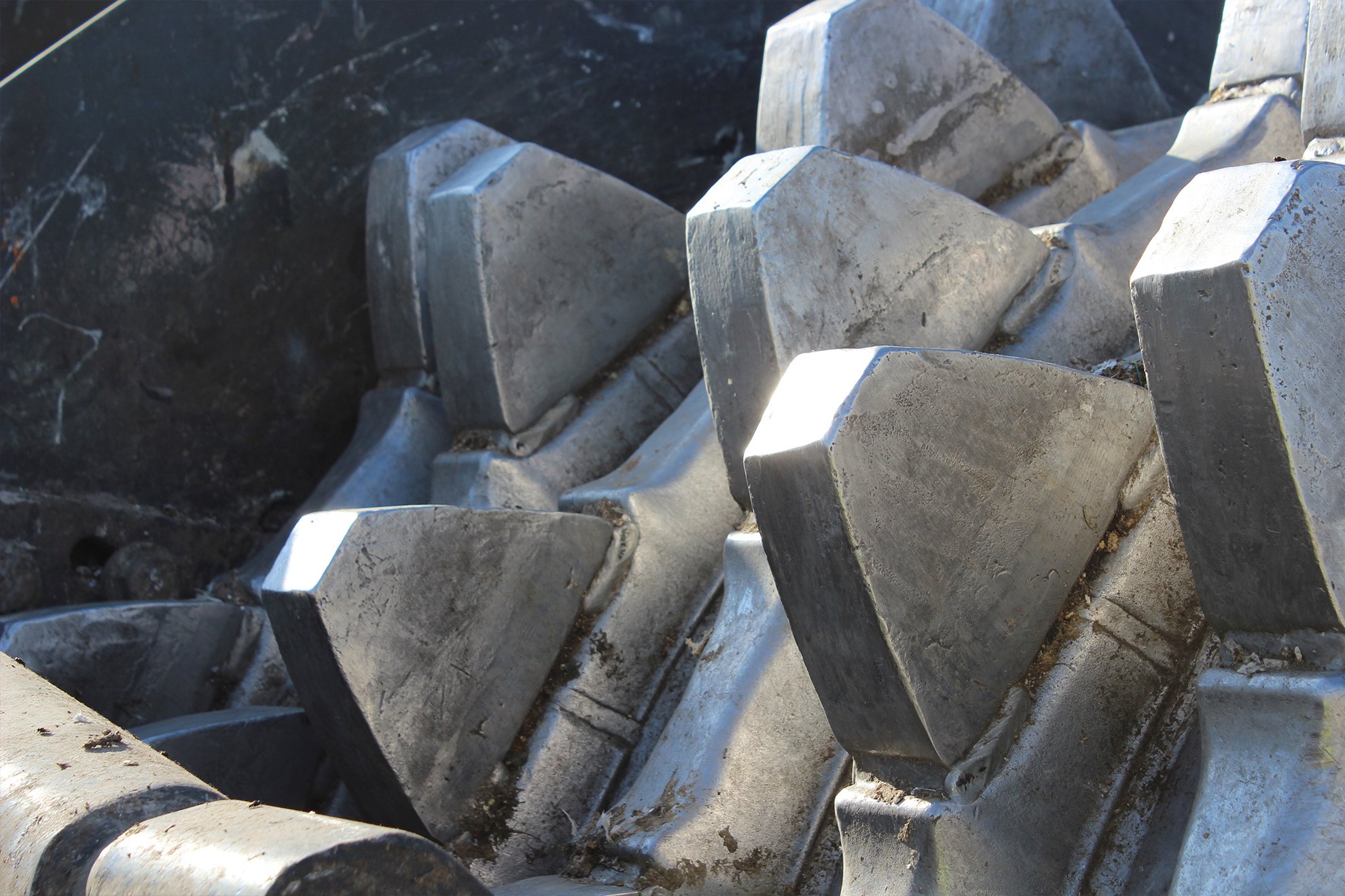 Landfill compactor wheel with steel tamping feet used to compact waste.
