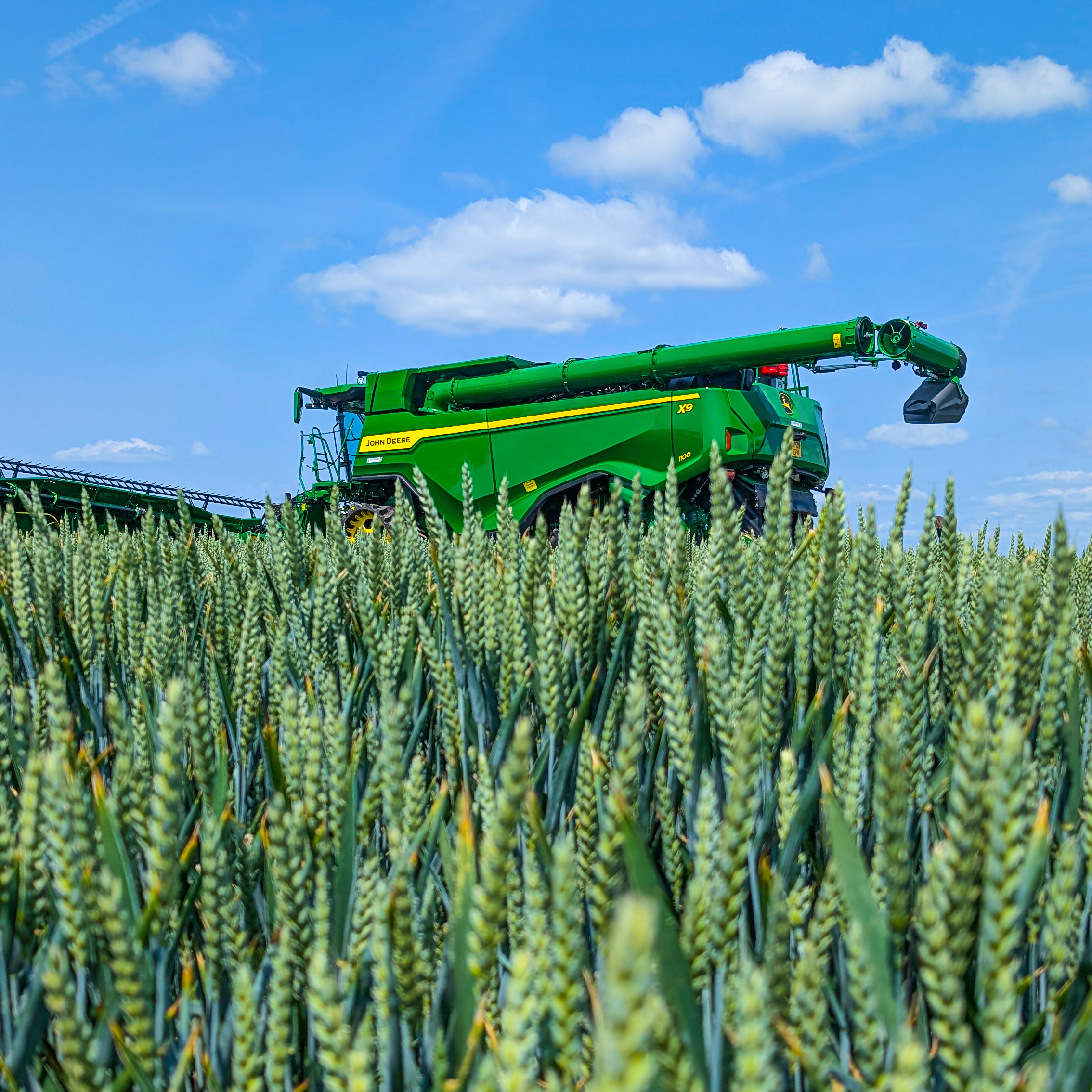 John Deere X9 Combine Harvester in a field of wheat