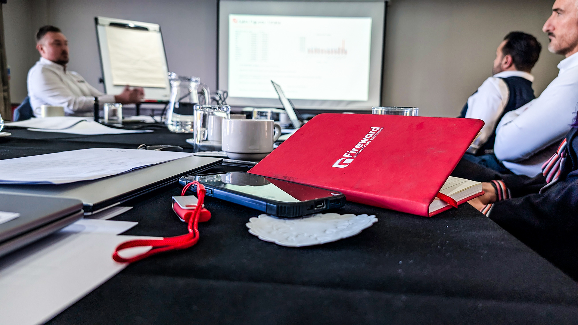 An image of a red  notebook branded with the Fireward logo