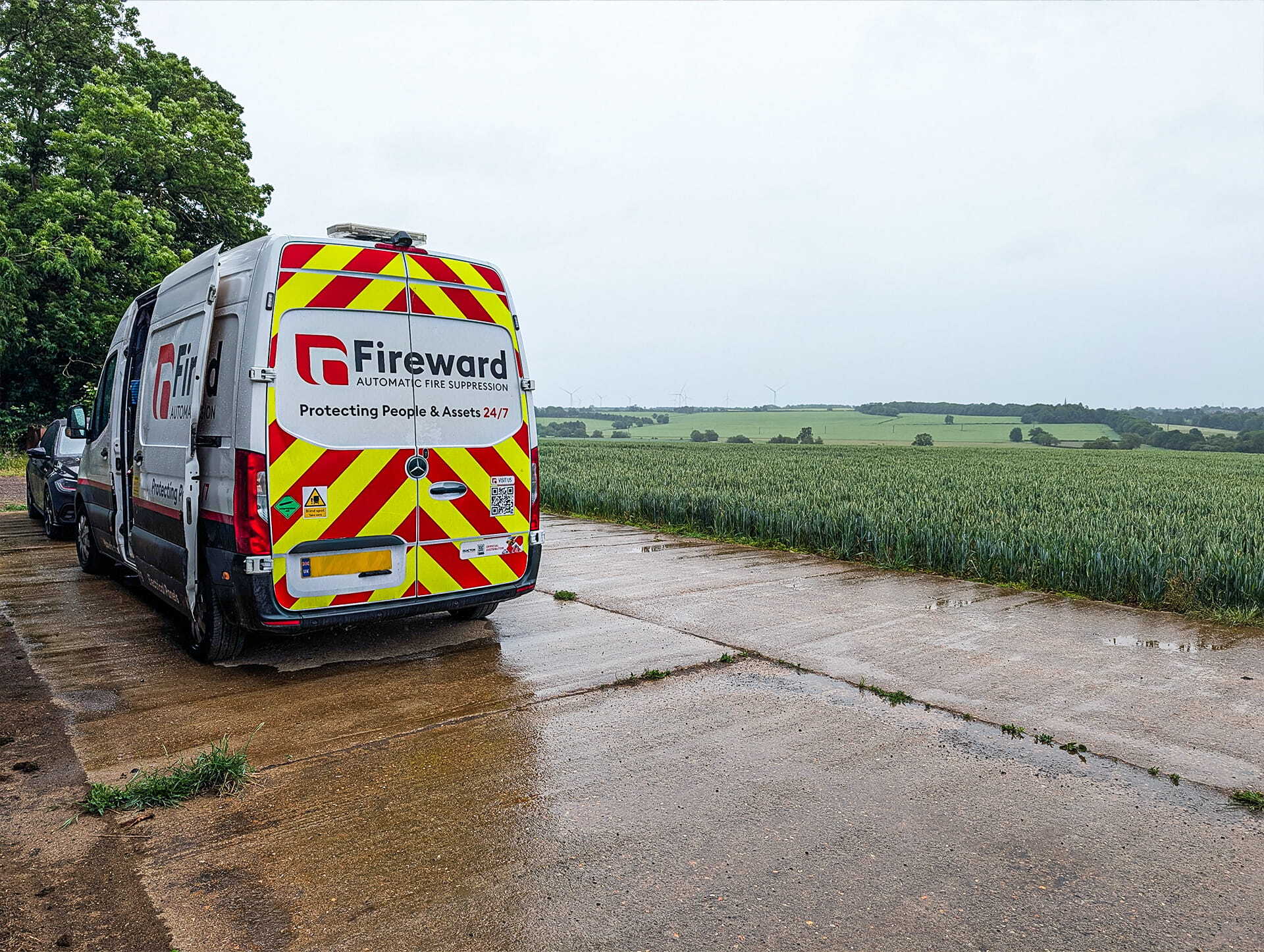 Fireward van parked next to a field of wheat at a farm