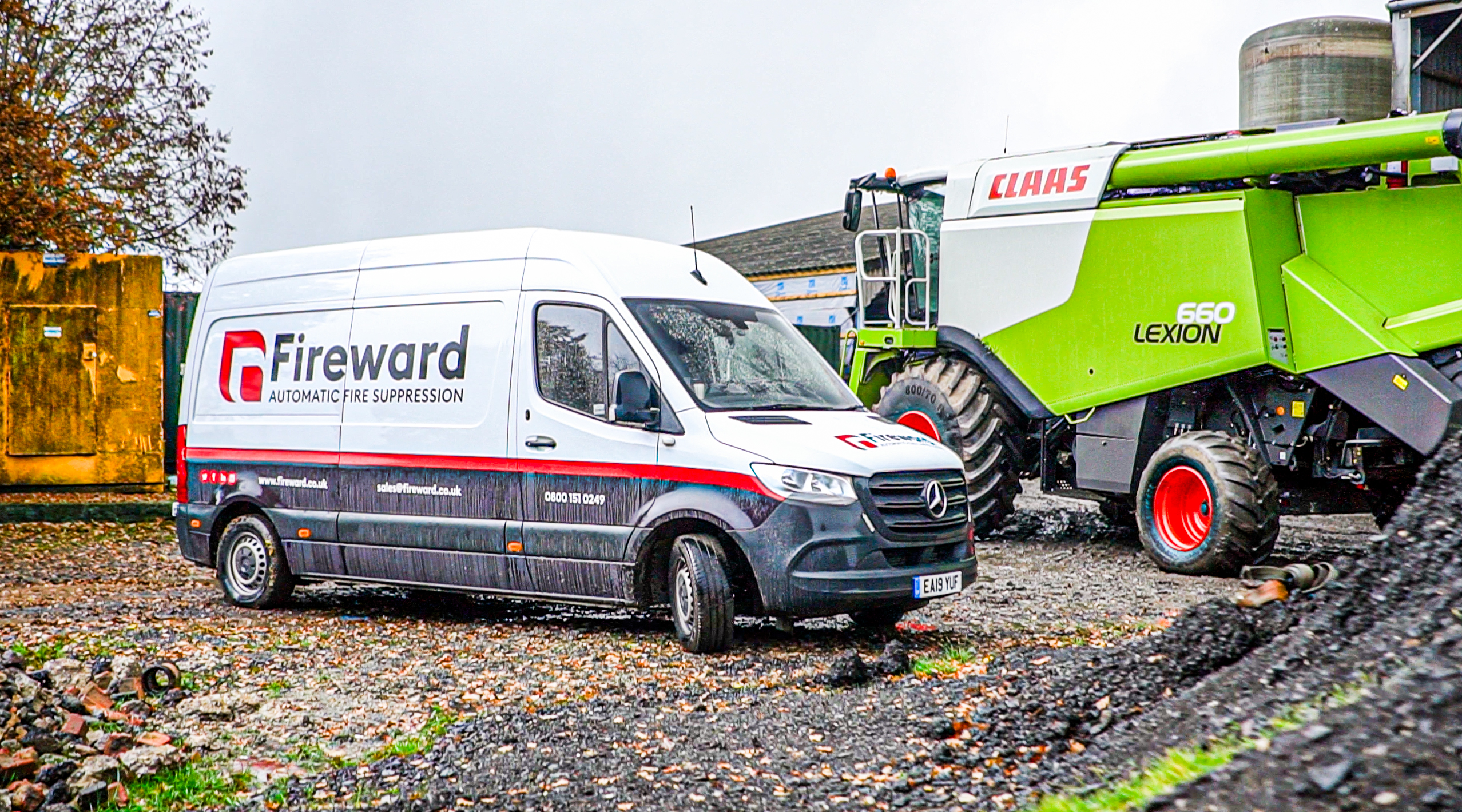 Fireward van parked next to a Claas Lexion 660 combine harvester